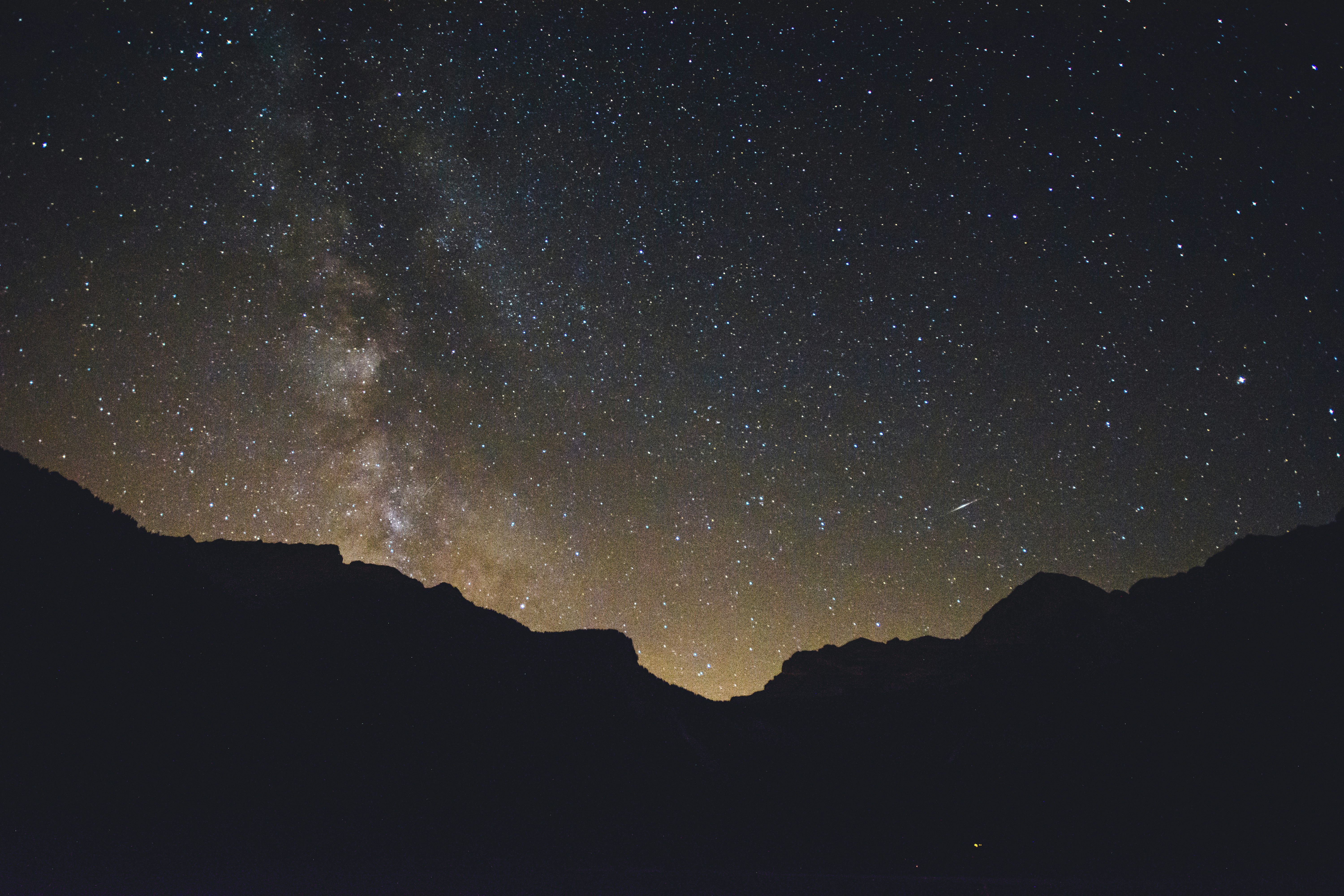 mountain silhouette under stars at nighttime